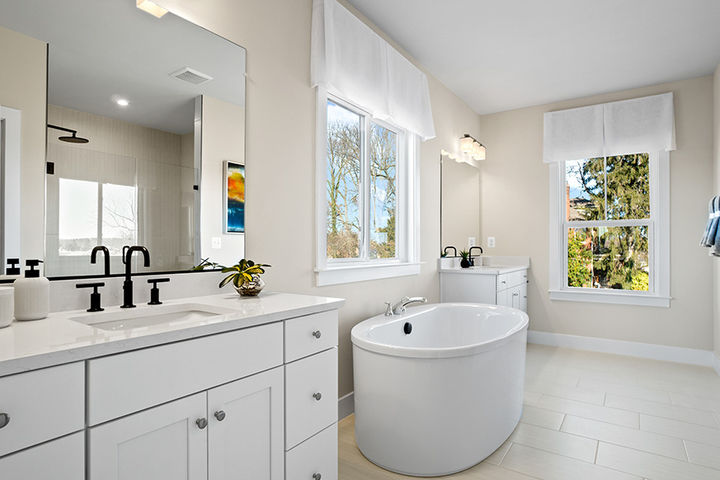 primary bath with tub in between vanities