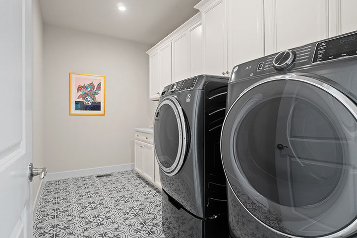 laundry room with cabinets and sink