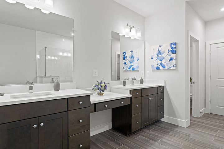 primary bath with separate cabinet vanities