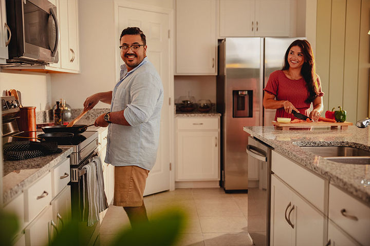 couple in kitchen cooking