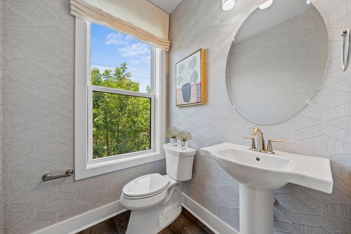 window and pedestal sink in powder room