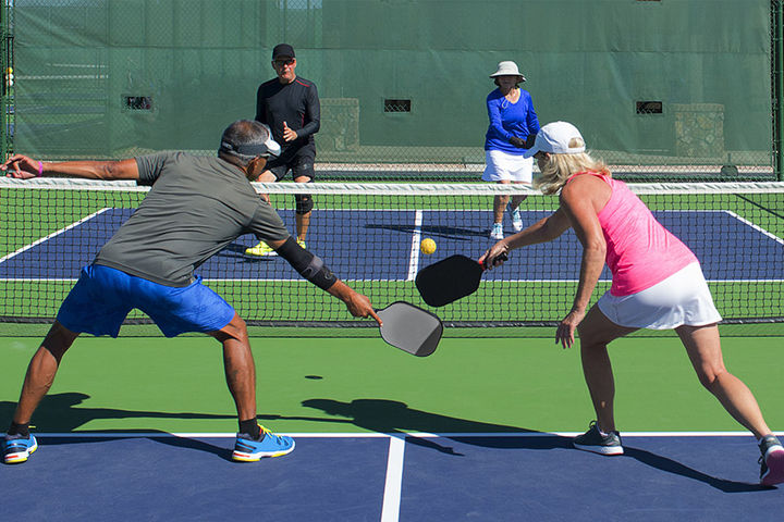 couples playing pickleball