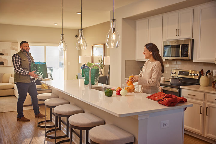 couple in open kitchen with large island