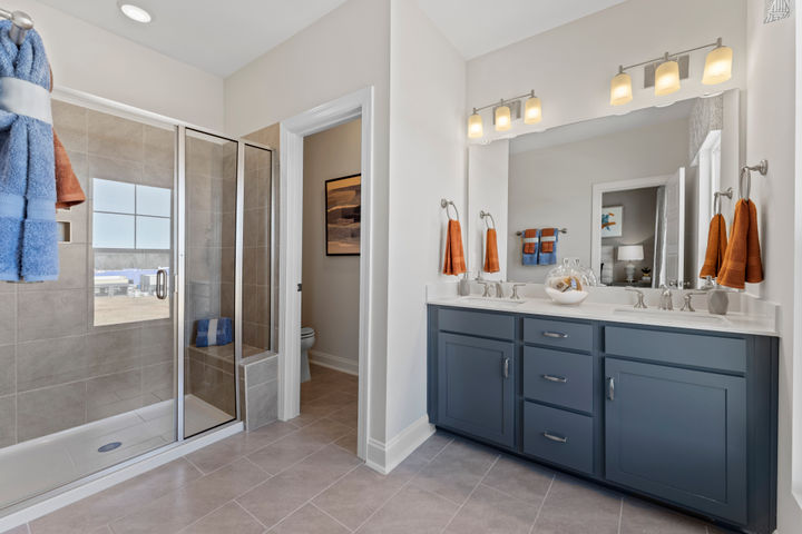 primary bath with tile shower and seat