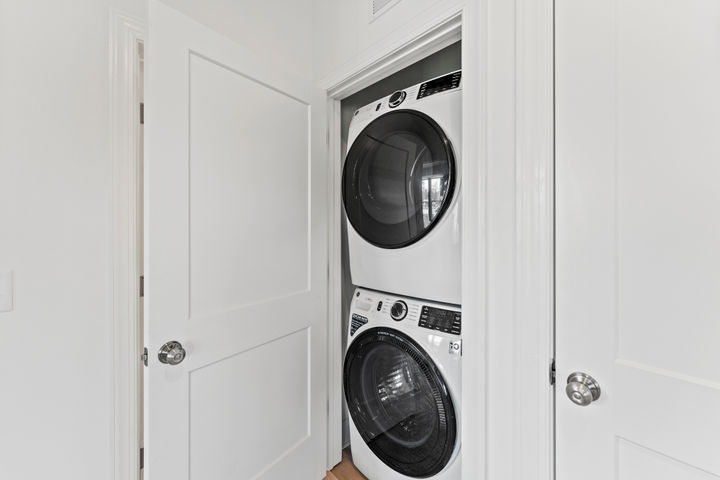 laundry room with stacked washer and dryer