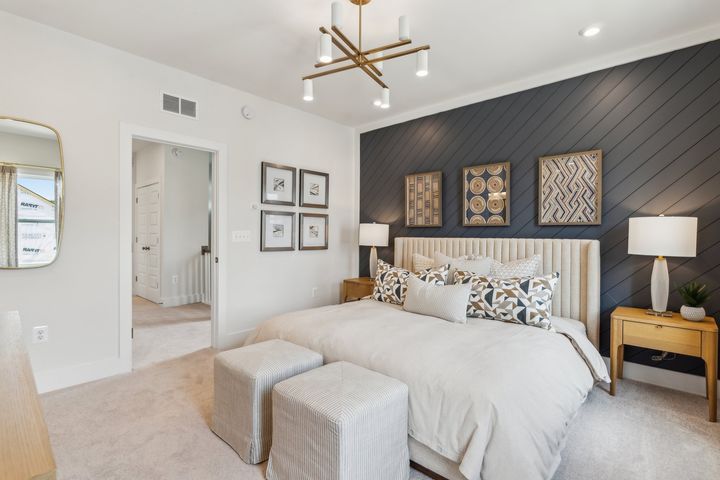 Serene primary bedroom with ensuite bath and walk in closets