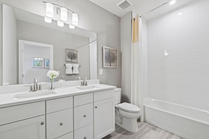 hall bath with tub shower and cabinet vanity