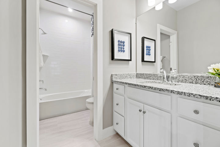 hall bath with tub shower and cabinet vanity