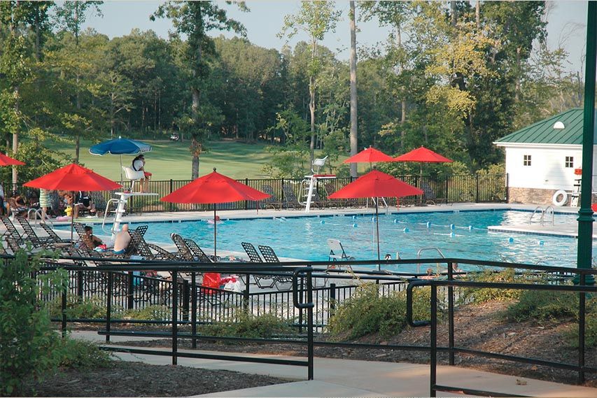 Community pool with umbrella seating and lounge chairs