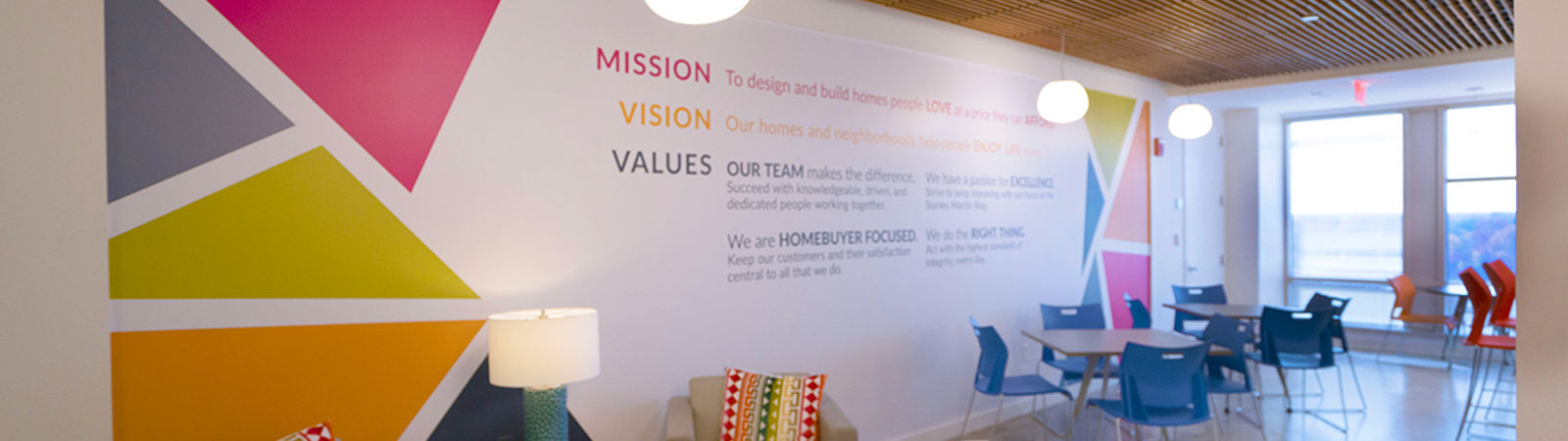 Two employees working at Stanley Martin Homes in the corporate office.