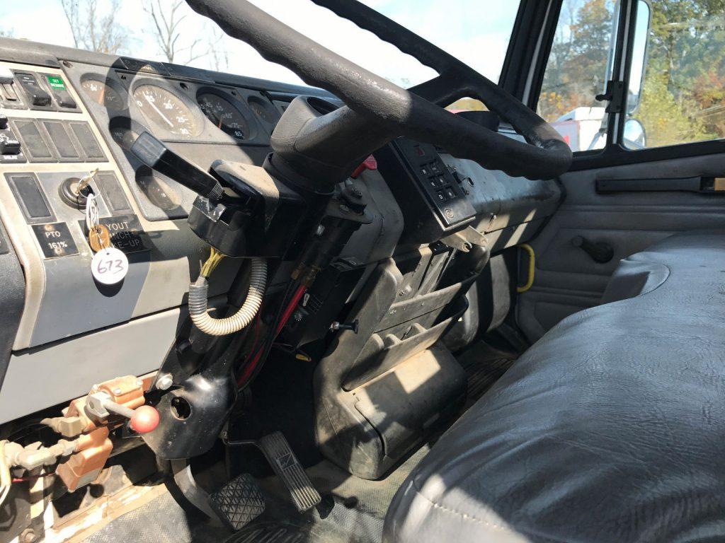 bucket worker 1999 Freightliner FL80 truck