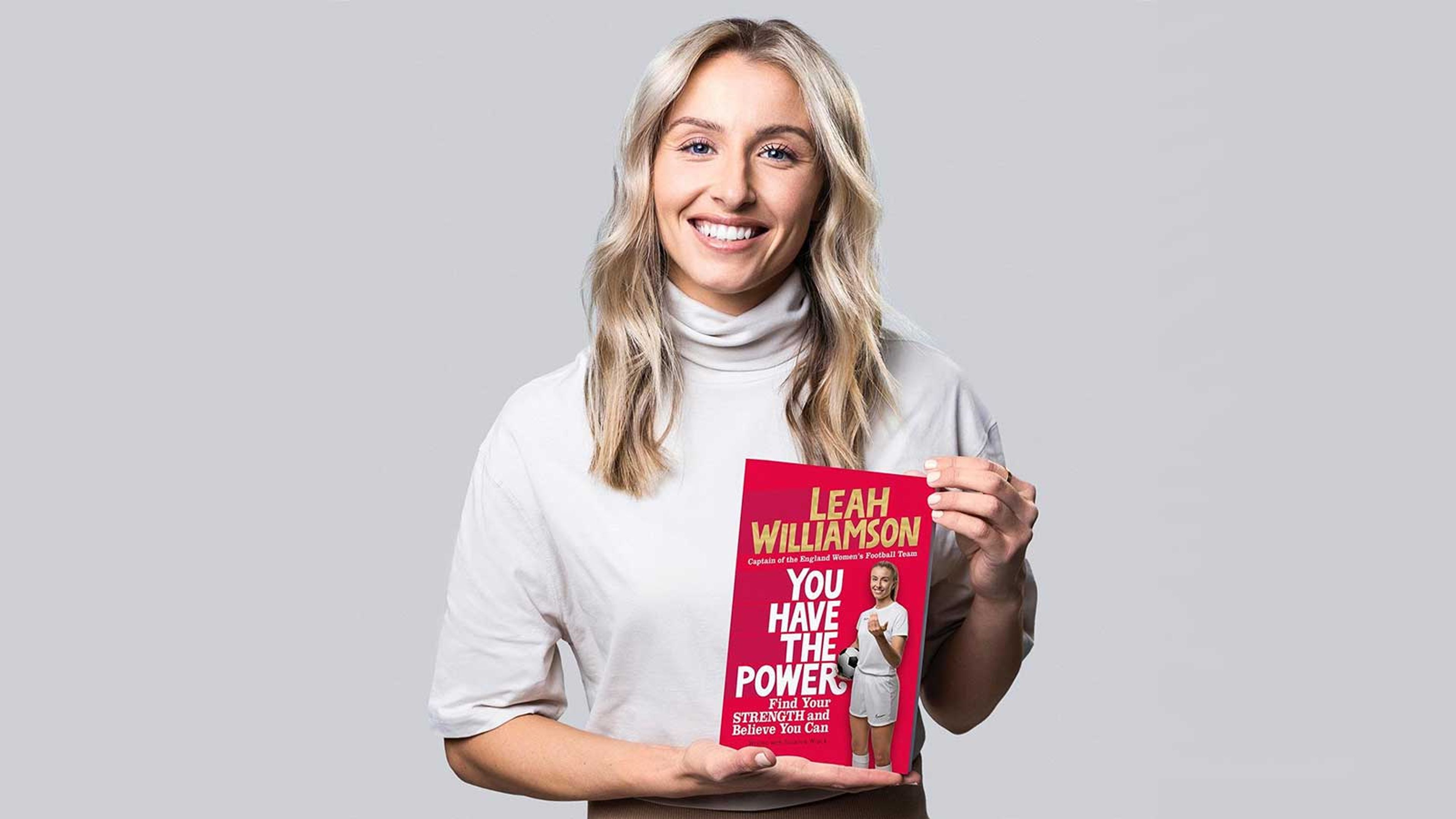 Leah Williamson hold a copy of her book