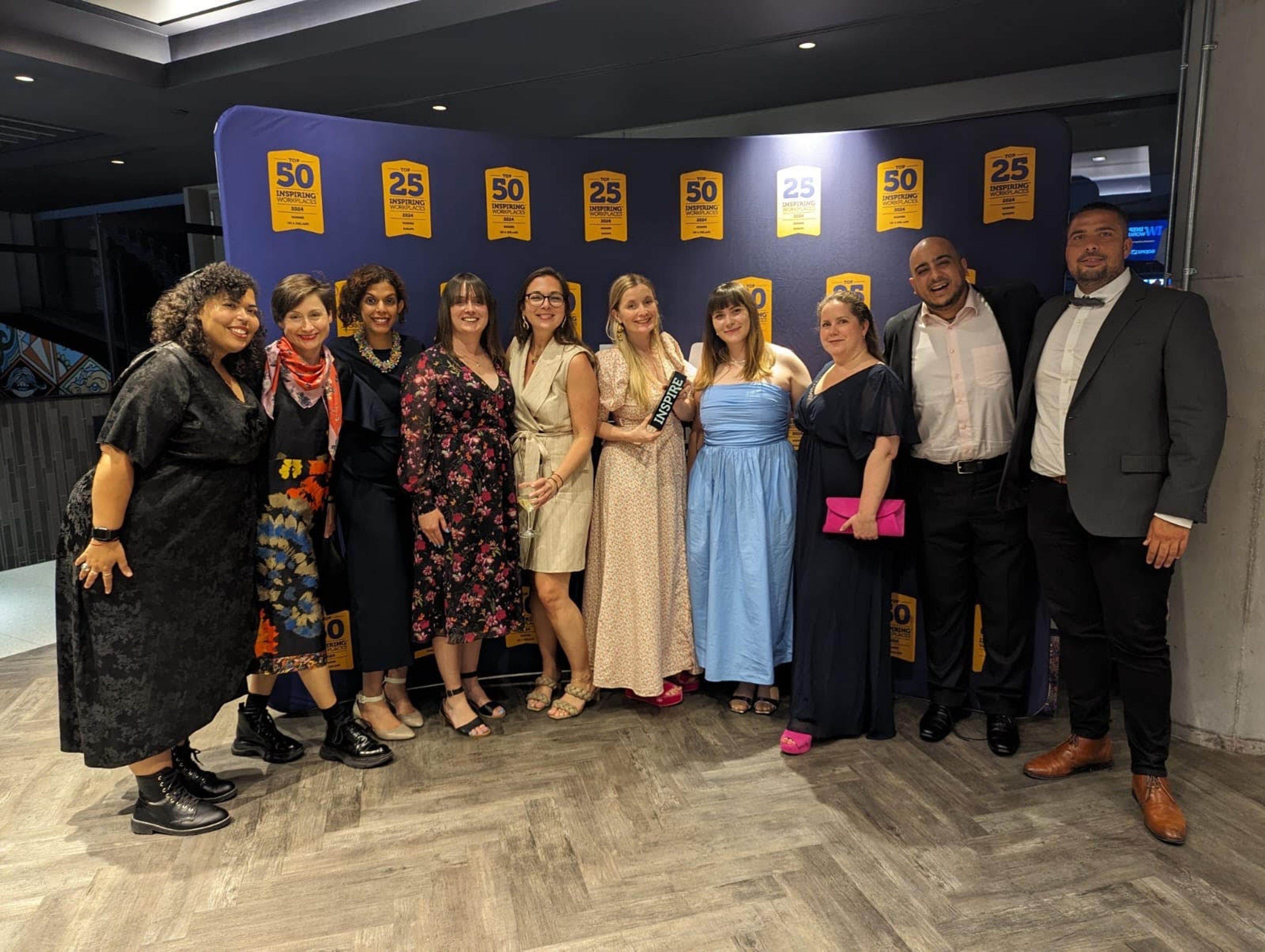 A group of Pan Macmillan employees celebrating at the Inspiring Workplace awards 2024