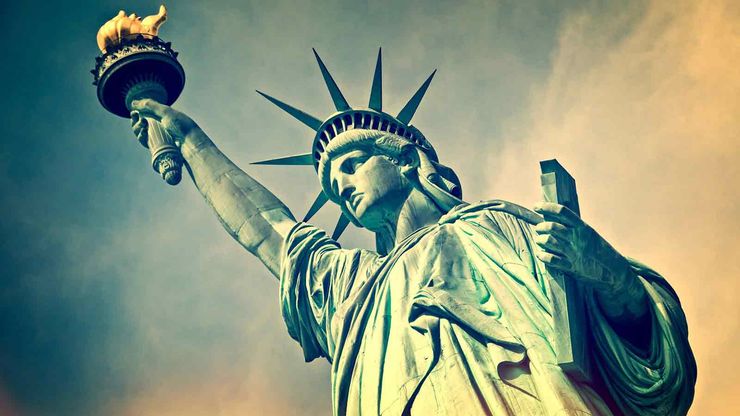 the Statue of Liberty with a blue sky behind it