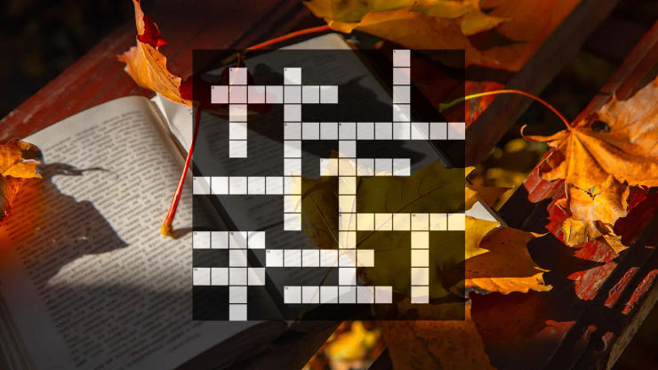 Empty crossword on background with book and autumn leaves