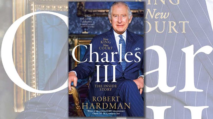 Cover art from the book Charles III: the King sits on a chair wearing a blue suit and tie