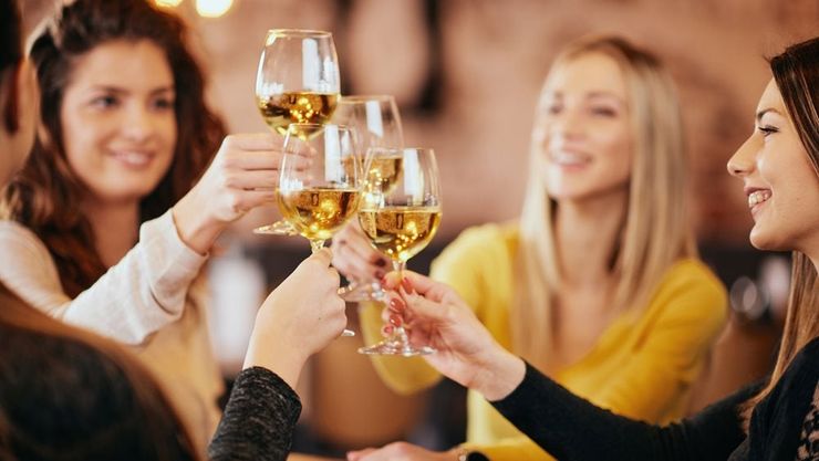 Women drinking white wine