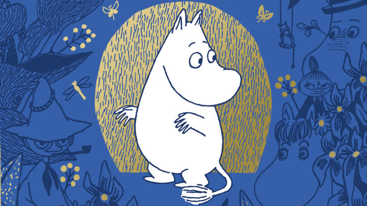 An illustration of Moomintroll standing in a gold surround on a dark blue background