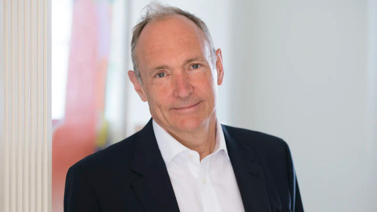 A photograph of Tim Berners-Lee wearing a white shirt and dark suit jacket