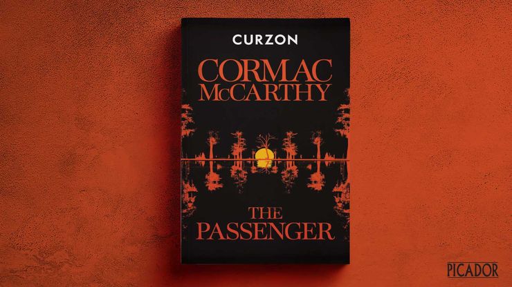 A special proof of Cormac McCarthy's The Passenger on a red background.