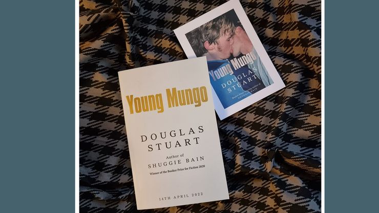 A proof copy of Young Mungo rests on a tartan scarf.
