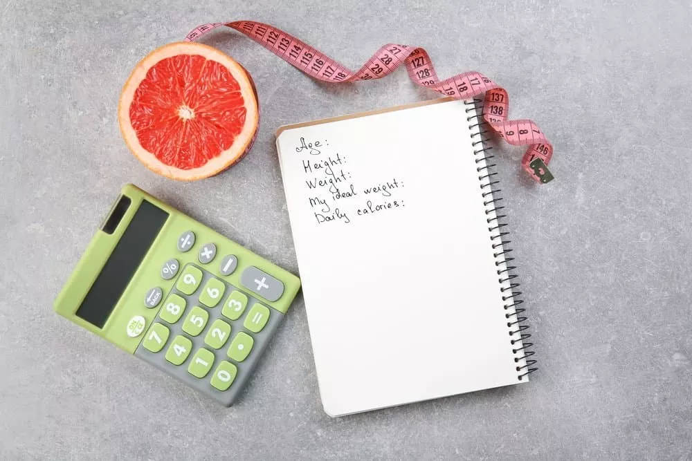 Diet concept. Measuring tape, grapefruit, calculator