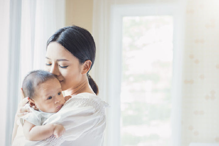 mom kisses baby