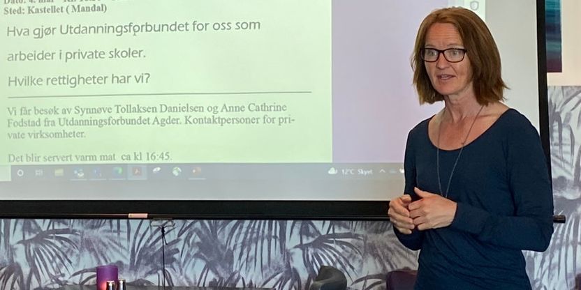 Vi ser bilde av Anne Cathrine Fodstad i halvprofil samt del av lerret med pp-presentasjon. 