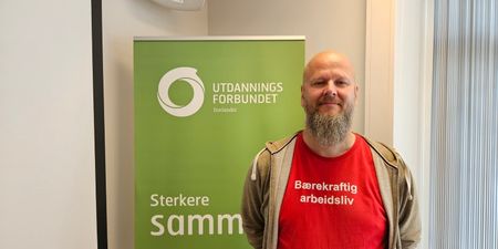 Bilde av Thore Johan Nærbøe foran en roll up med påskriften sterkere sammen.