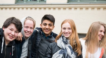 5 teenagers embracing each other. Photo. 