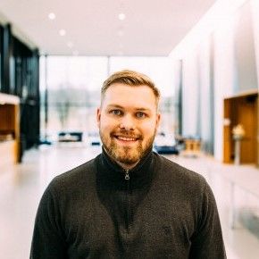 Bilde av Kasper Faugli Åvitsland. Mann i sort genser smiler mot kamera. Han har kort, lyst hår og litt skjegg. Foto. Fotograf: Adrian Castillo. 