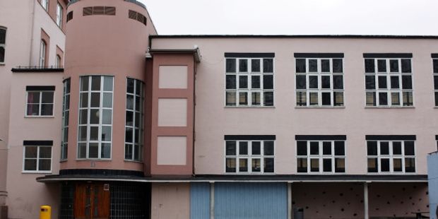 Bilde av en skolefasade med mange vinduer. Foto.