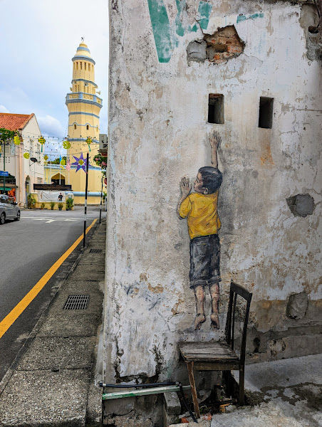 Penang Street Art - Boy on Chair by Ernest Zacharevic