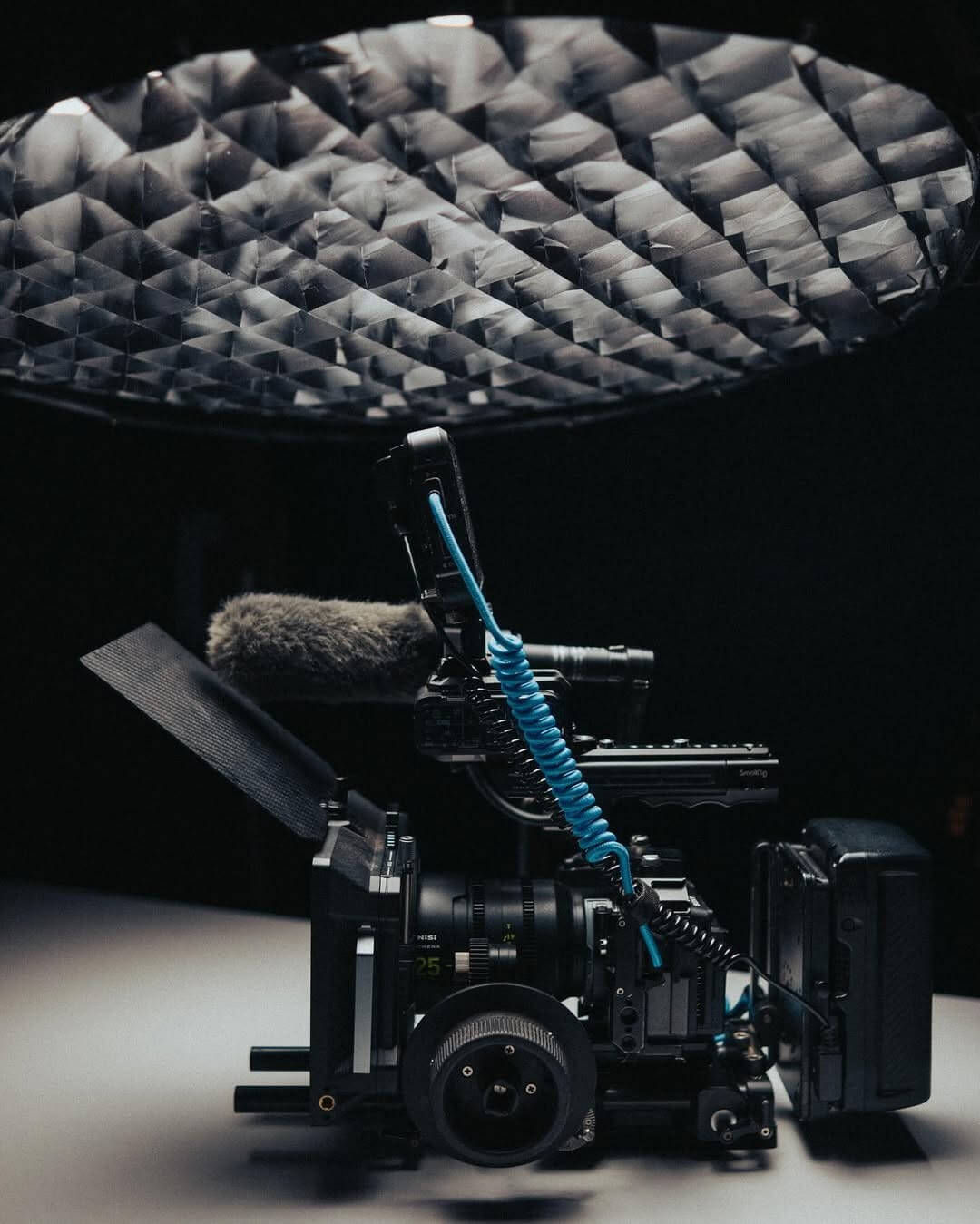 Cinema camera operator filming a brand commercial on a professional production set.