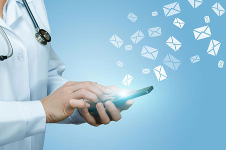 Doctor checking email on phone