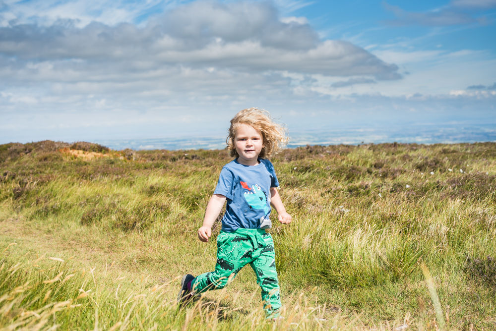 Albert running through sumit, Binsey, Lake District photographers
