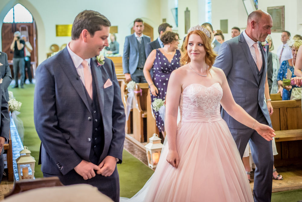 Bride meets groom at top of aisle, Otley Wedding photographers