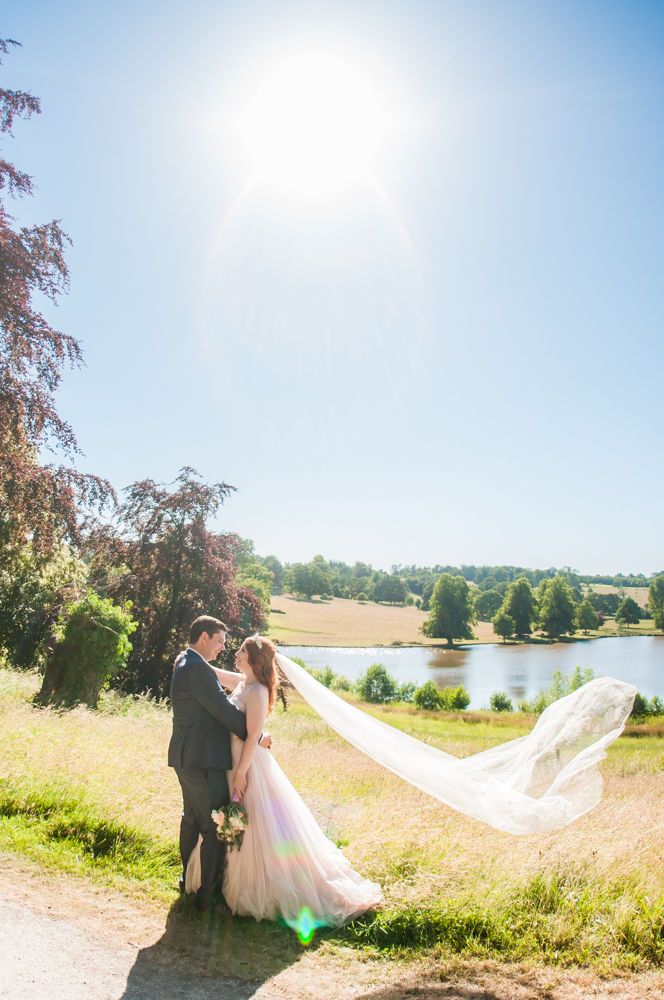 Bride and groom in the castle grounds with lake in background, Ripley Castle weddings, Yorkshire wedding photographers