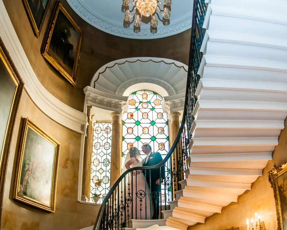 Bride and groom on stairs in castle, Ripley Castle weddings, Yorkshire wedding photographers