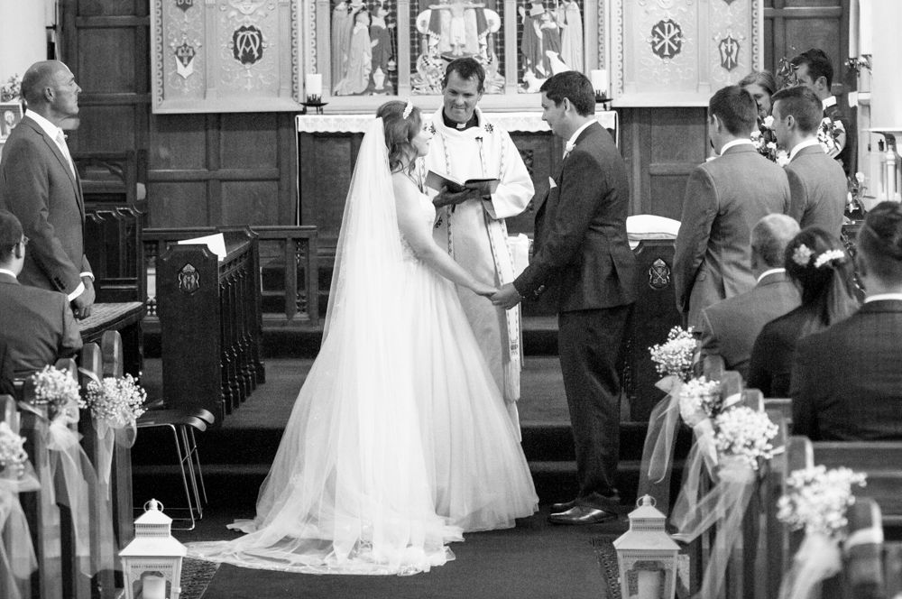 Bride and groom exchanging vows, Burley in Wharfedale church, Yorkshire wedding photographers
