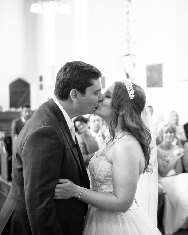 Bride and groom kiss in church, Burley in Wharfedale church, Yorkshire wedding photographers