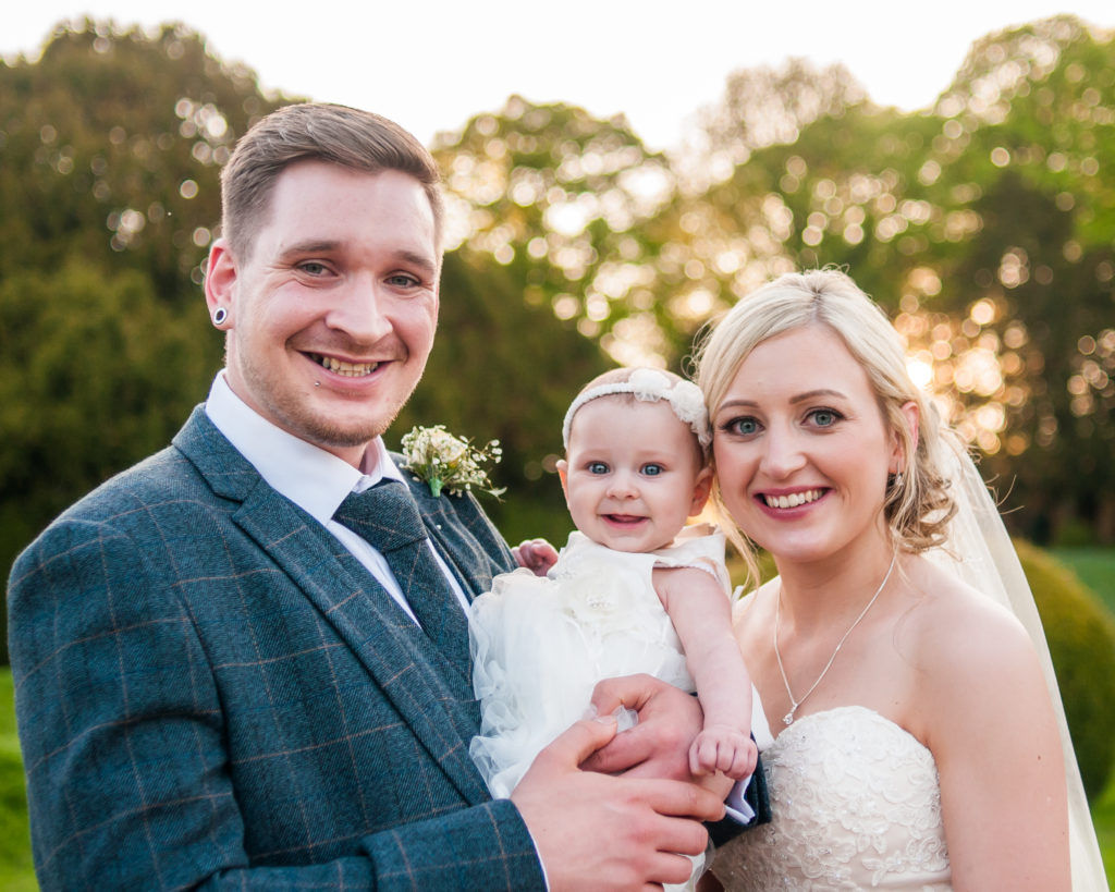Bride and groom with daughter posing, Wortley Hall, Sheffield wedding photography