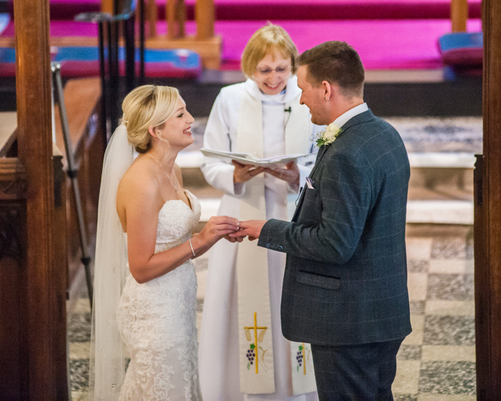 Bride and groom exchanging rings at church, Wortley Hall, Sheffield wedding photography