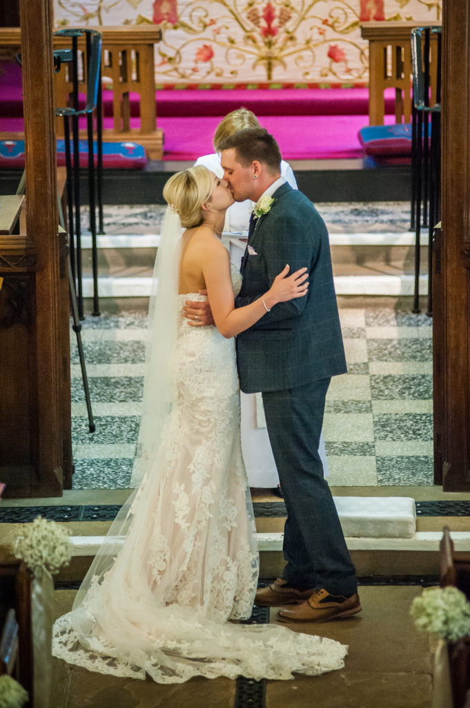 Bride and groom first kiss in church, Wortley Hall, Sheffield wedding photography