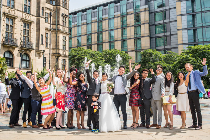 Wedding party cheering in the Peace Gardens