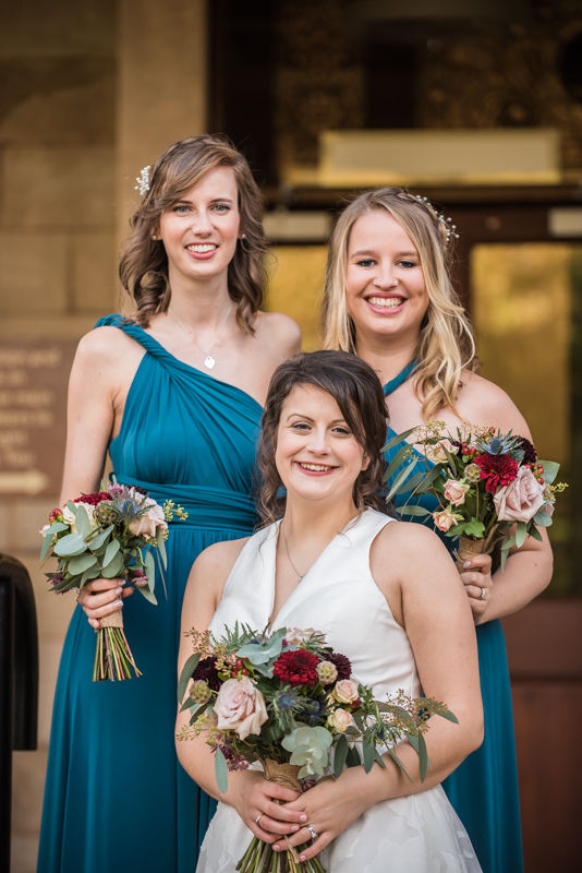 Bride and bridesmaids smiles outside Halifax Hall in Sheffield