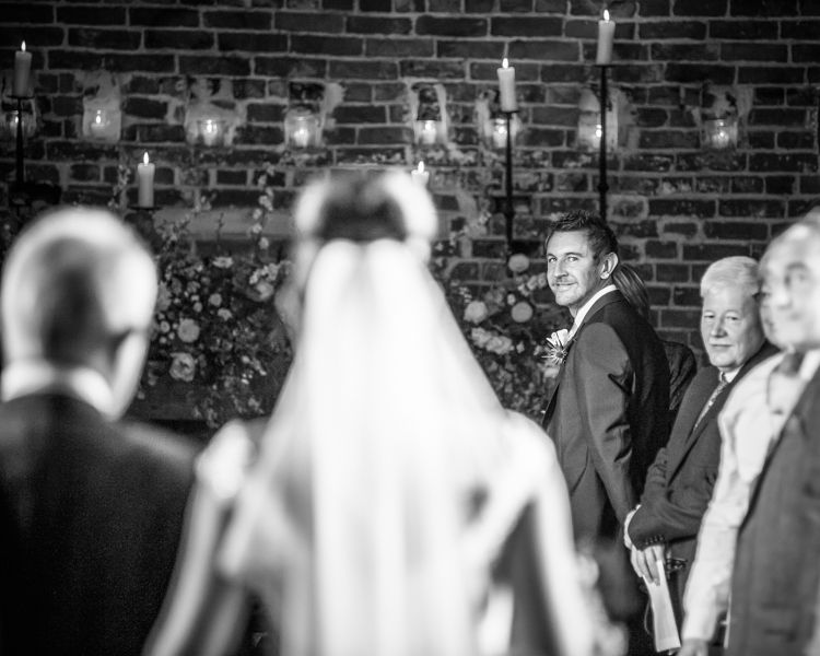 Scott looking back at Joelle at their Sheffield wedding at Hazel Gap Barn
