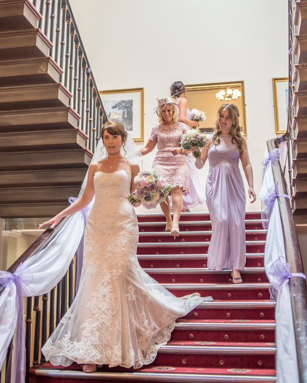 Bridal party coming down the stairs at Wortley Hall