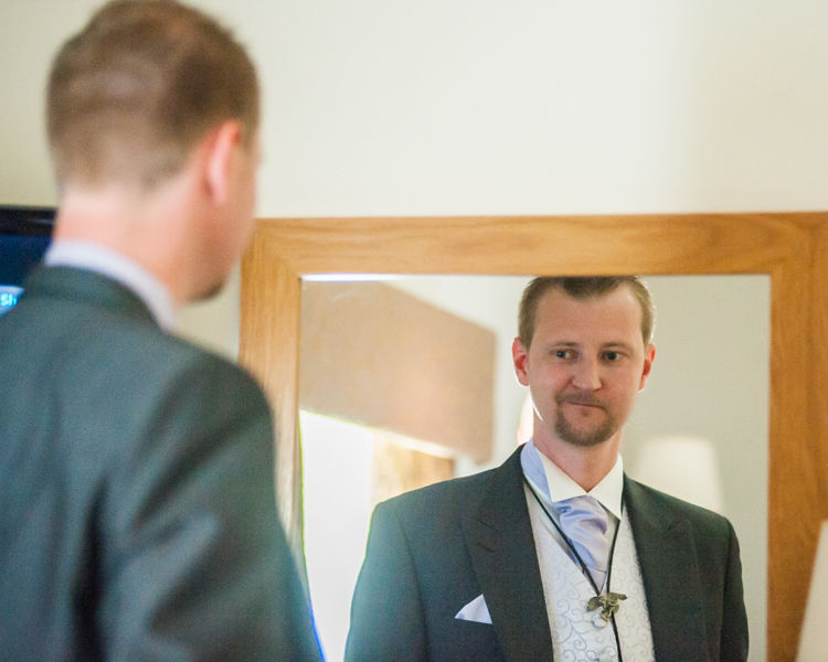 Groom's reflection in mirror at Wortley Hall