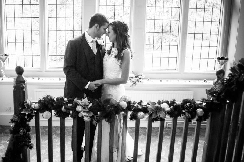 Kisses on staircase Sheffield wedding photographers Whirlowbrook Hall